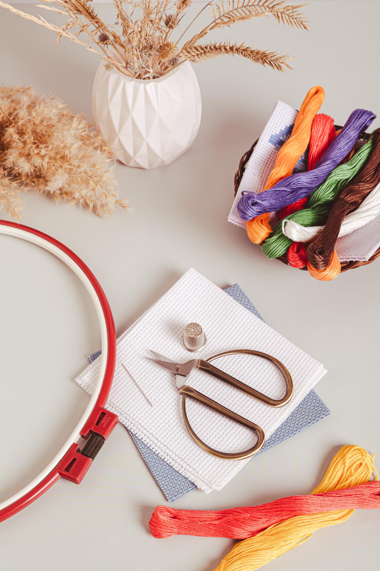 Workshop table with embroidery hoops and tools